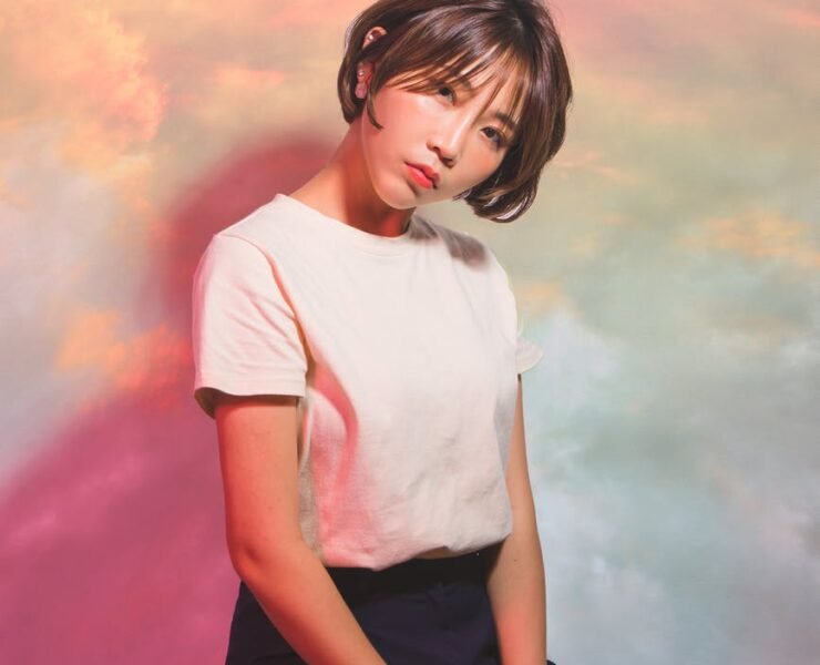 woman in white crew neck t shirt and black pants sitting on the chair