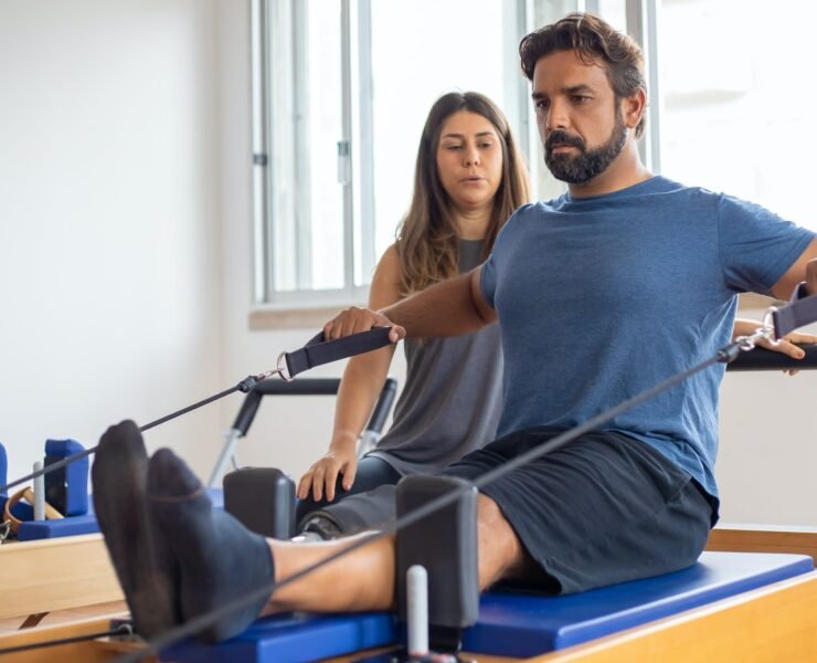a man in blue shirt exercising with supervision