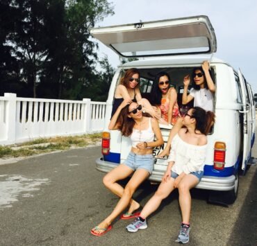 photo of five women sitting in back of van