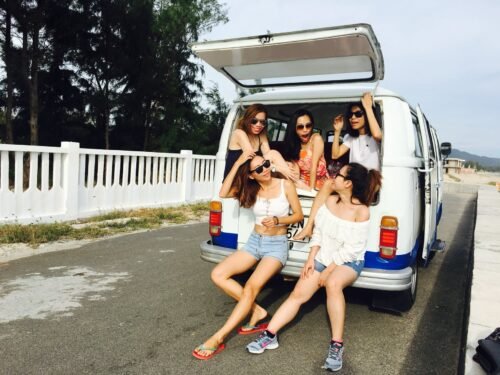 photo of five women sitting in back of van