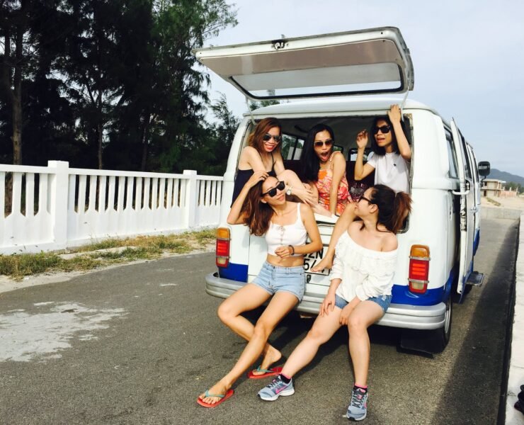 photo of five women sitting in back of van