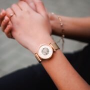 Woman’s hands wearing a rose-gold mechanical watch