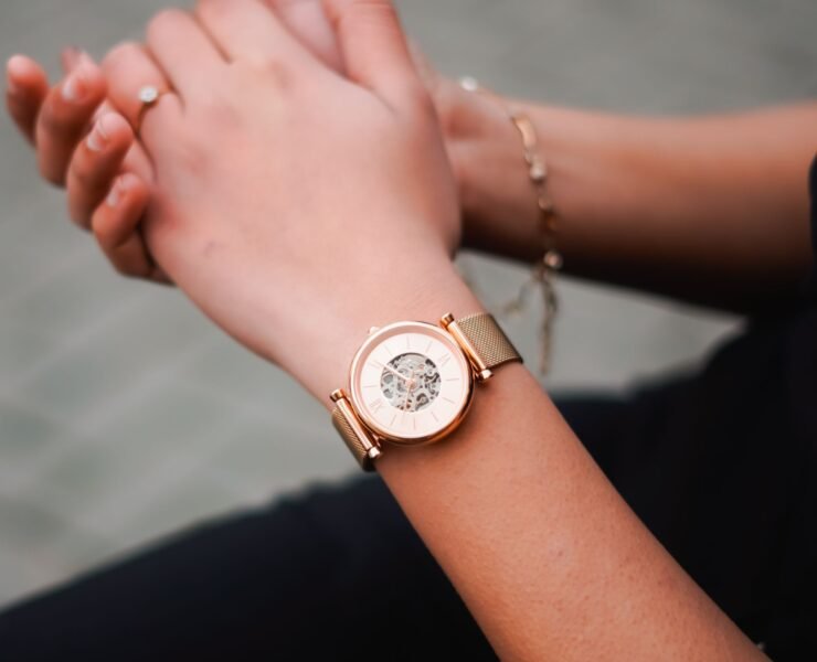 Woman’s hands wearing a rose-gold mechanical watch